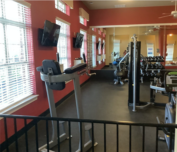 A gym with workout equipment.