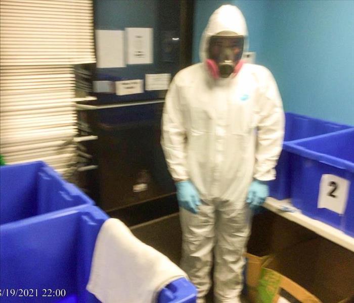 Team member in protective gear before cleaning