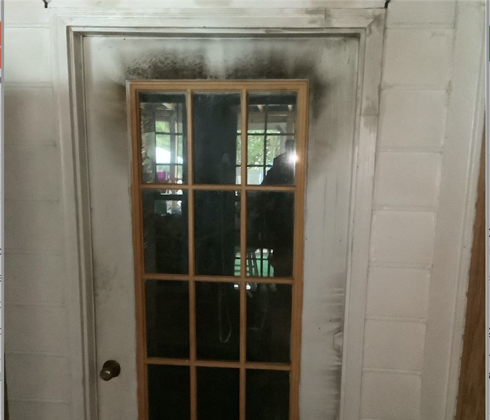 Soot on door after a fire.