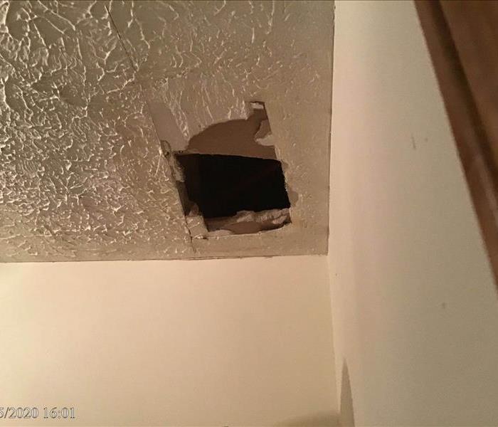 ceiling in a storage closet caved in due to water damage